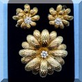 J03. Gold and diamond brooch with matching earrings. 